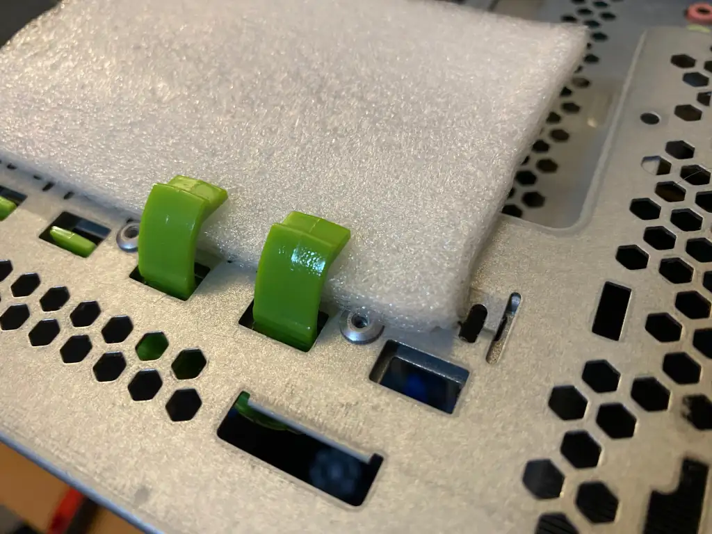 Two PCIe card clasps curing after being re-assembled with epoxy resin.